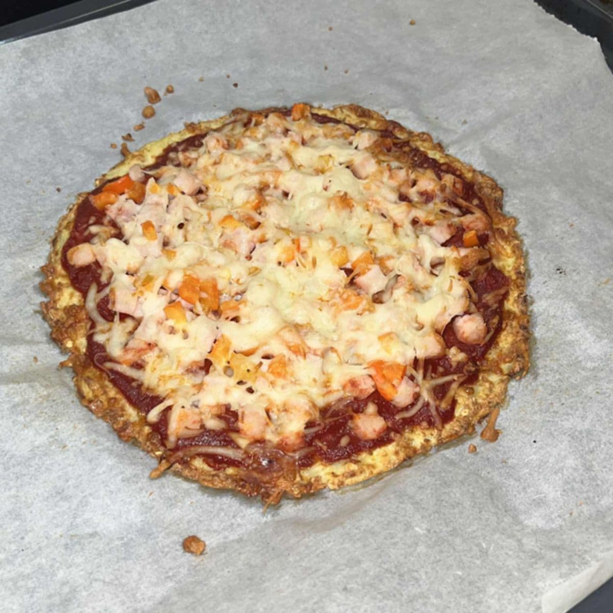 Klar til servering – en sprød, gylden blomkålspizza klar til at nyde!