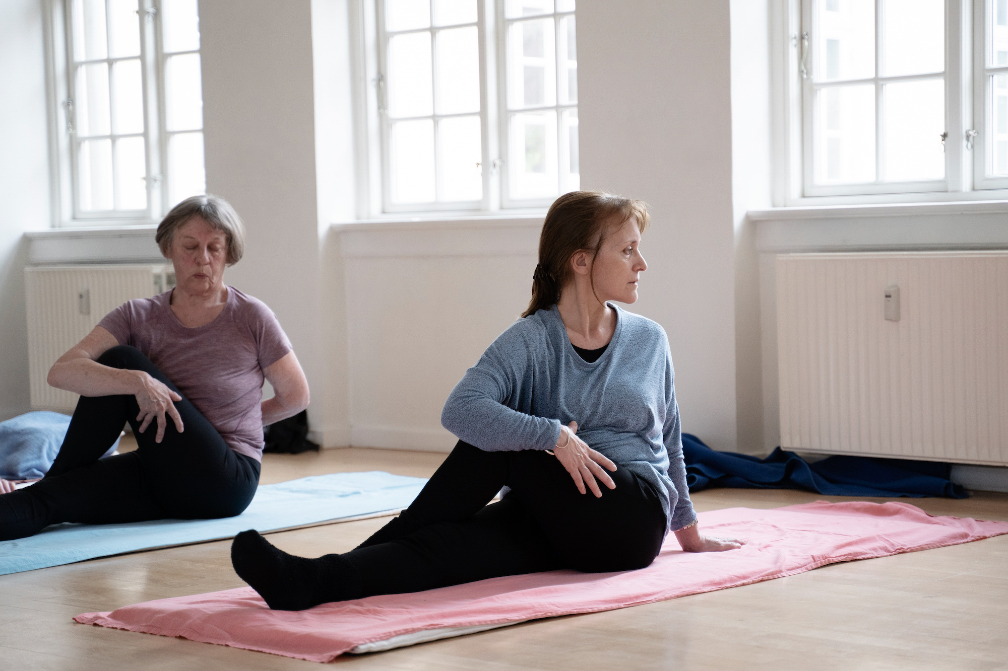 Deltager udfører hatha-yogastilling i roligt lokale