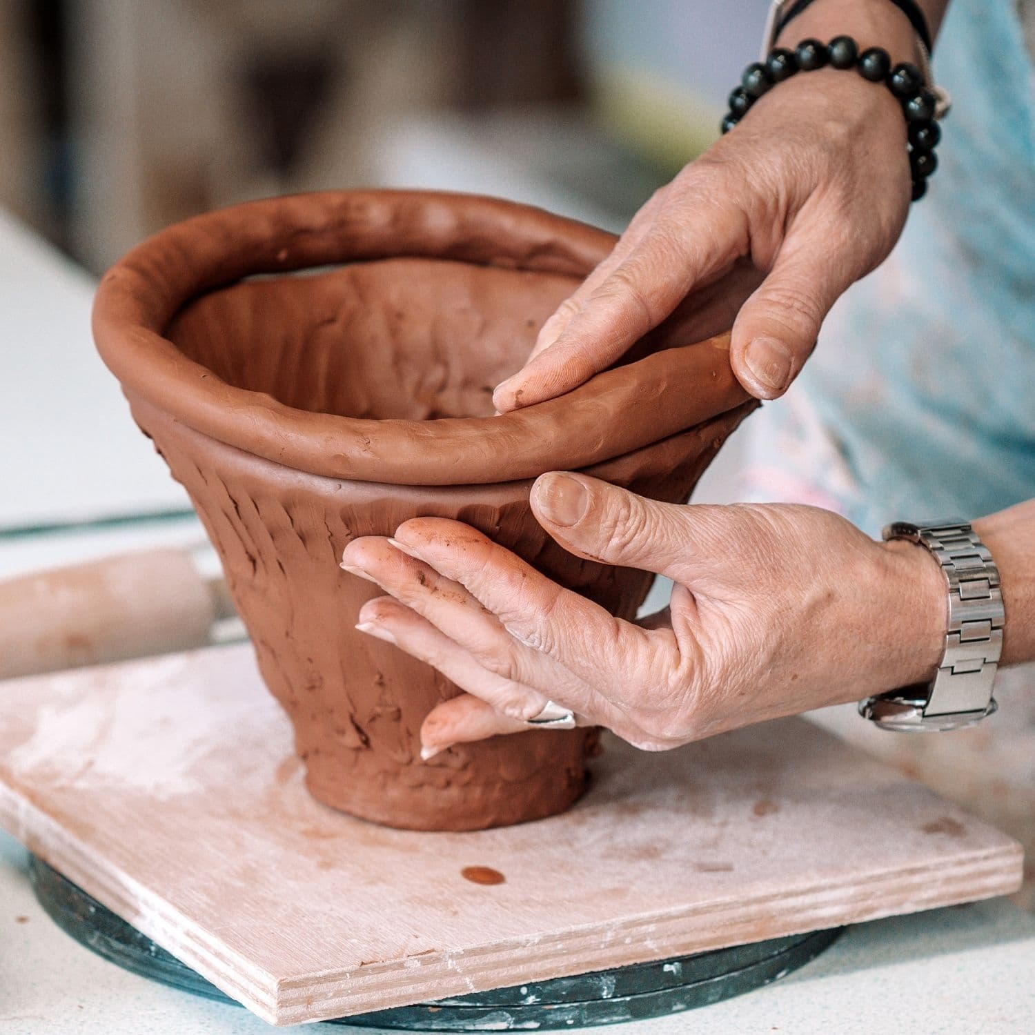 Kursist der bruger pølseteknik til at opbygge en skål af lertøjsler
