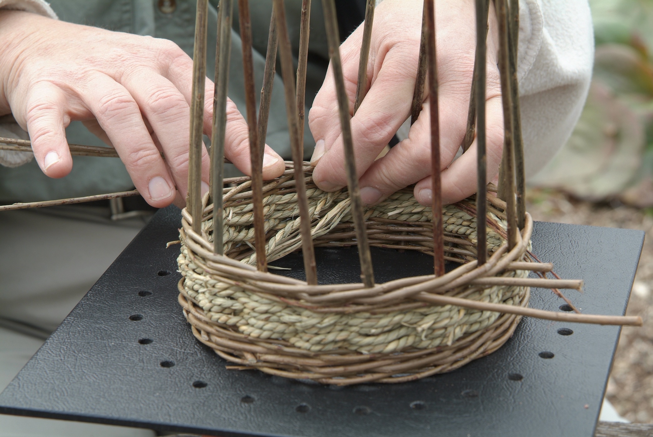 Kursist arbejder med pileflet til haven på aftenskolekursus